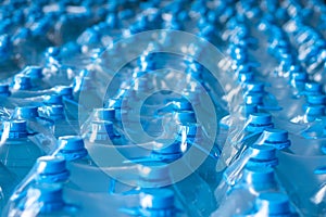 Blue plastic bottles of 5 liters packed in the finished product warehouse