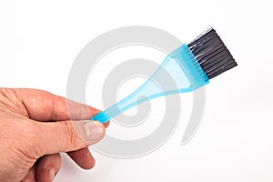 Blue plastic brush used for hair coloring in hairdressers