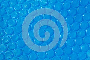 Blue plastic bubble wrap texture.