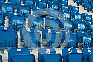 Blue plastic chairs on the stands of the sports hall