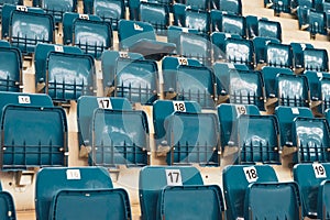 Blue plastic chairs on the stands of the sports hall