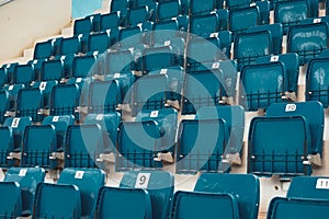 Blue plastic chairs on the stands of the sports hall photo
