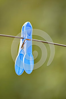 Blue plastic cloth peg on a washing line