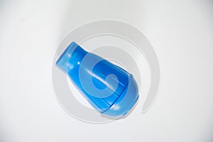 The blue plastic object is placed in the center of a pure white background, with a unique shape and textured surface