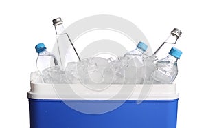 Blue plastic cool box with ice cubes and bottles of water on white background