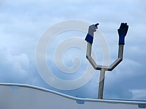 Blue plastic gloves on metal contraption on fishing boat