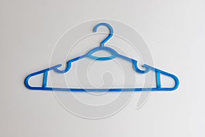 Blue plastic hanger on white background