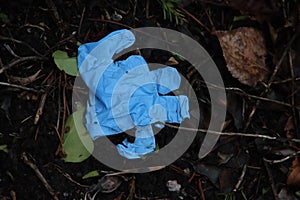 Blue plastic latex glove thrown away on the streets of Zuidplas during the corona crisis photo