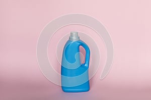 Blue plastic liquid detergent bottle isolated on pink background. Laundry container, merchandise template. Product