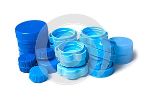 blue plastic plugs for recycling on white background