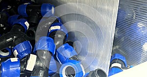 Blue plastic plumbing pipe adapters in a store