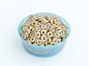 Blue plastic round medium size bowl for loose products filled with honey nuts isolated on a white background