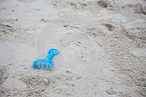 Blue plastic sand construction toy on sand beach