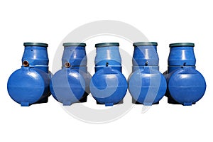 Blue plastic septic tanks are standing. Five cylindrical containers in a row. Isolated white background, a large of sewage