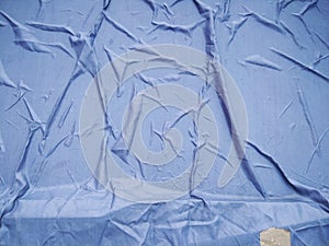 The Blue Plastic sheet on the Car for dust and rain protection. photo