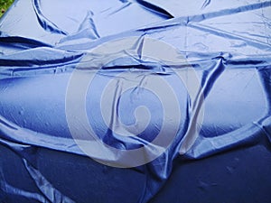 The Blue Plastic sheet on the Car for dust and rain protection. photo