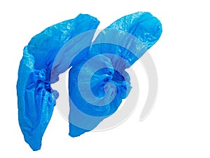 Blue plastic shoe protectors, covers isolated on white background. Hygiene in medical situations etc. Single use