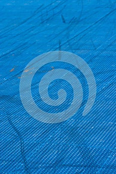 Blue plastic texture playground with trails on it.