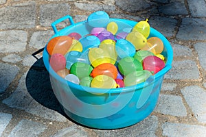 Blue plastic tub filled with water bombs