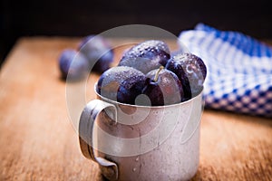 Blue plums in cup