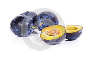 Blue plums on white background