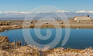 Blue Pond with Snowcapped Mountains