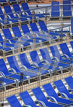 Blue pool chairs arranged in a row