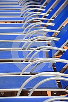 Blue pool chairs arranged in a row