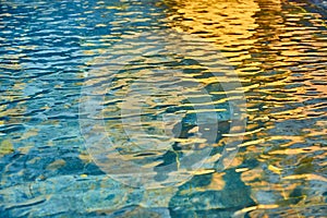 Pool transparent water with sun reflections