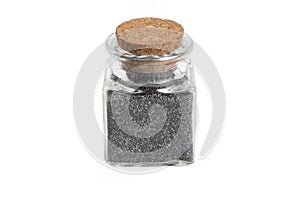 Blue poppy seeds in a glass jar isolated on white background. food ingredient