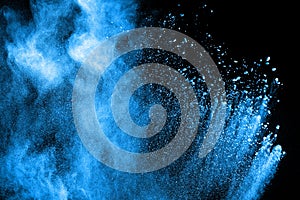 Blue powder explode cloud on black background. Launched blue dust particles splash on background