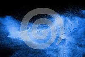 Blue powder explode cloud on black background. Launched blue dust particles splash photo