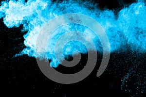 Blue powder explosion on white background.