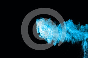 Blue powder explosion on white background.