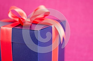 Blue present box with red ribbon isolated