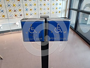 Blue press to operate door wheelchair button or symbol