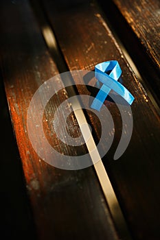 Blue prostate ribbon on wooden bench