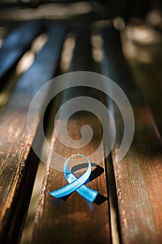 Blue prostate ribbon on wooden bench