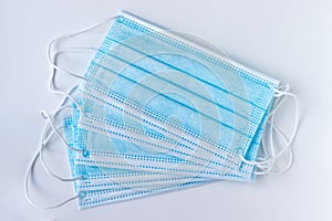 Blue protective medical face masks on a white background. Respiratory protection during quarantine, virus, coronavirus