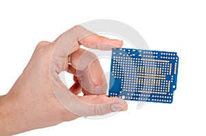 Blue prototyping PCB in a hand