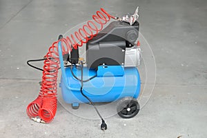 Blue pump compressor for washing cars, indoor. Cleaning concept.