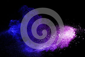 Blue purple dust explosion on black background