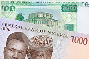 A blue, purple and green one thousand  naira note from Nigeria paired with a green one hundred ruble note from Belarus.