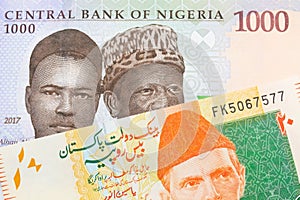 A blue, purple and green one thousand  naira note from Nigeria paired with a orange and green 20 rupee note from Pakistan.