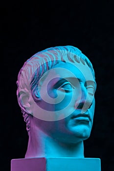 Blue purple gypsum copy of ancient statue of Germanicus Julius Caesar head for artists isolated on black background