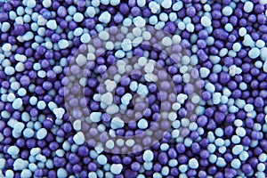 Blue and purple hundreds and thousands sprinkles sugar beads used for decorating cakes and desserts