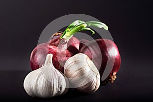 Blue purple onion and garlic isolated white on a black background