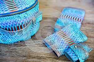 Blue python leather product on wooden background