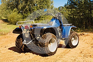 Blue quad on sand on the road, safari