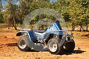 Blue quad on sand on the road, safari